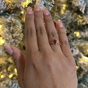 14K (marked 585) rose gold ring with large emerald cut red center stone